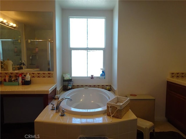 43890 Moccasin Pl, Lancaster, CA 93536 - full bathroom featuring a garden tub, a shower stall, plenty of natural light, and vanity