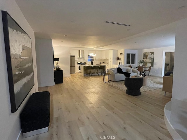 20406 Londelius St, Winnetka, CA 91306 - living room with light wood finished floors and baseboards