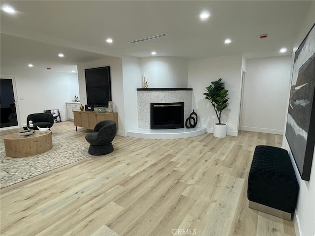20406 Londelius St, Winnetka, CA 91306 - living room featuring light wood finished floors, a fireplace with raised hearth, and recessed lighting