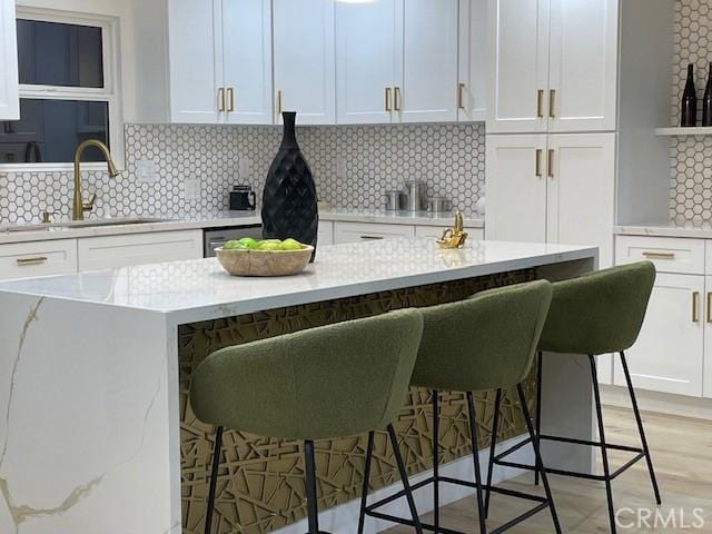 20406 Londelius St, Winnetka, CA 91306 - kitchen featuring white cabinetry, a kitchen bar, tasteful backsplash, and open shelves