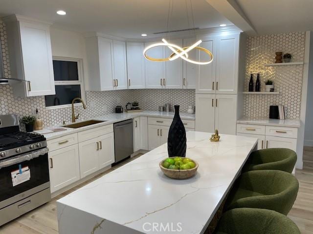 20406 Londelius St, Winnetka, CA 91306 - kitchen with appliances with stainless steel finishes, open shelves, backsplash, white cabinetry, and a breakfast bar