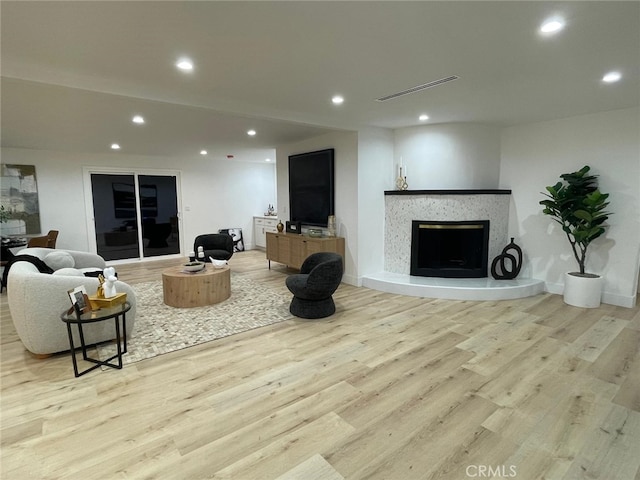 20406 Londelius St, Winnetka, CA 91306 - living room featuring recessed lighting, light wood-style floors, and a premium fireplace