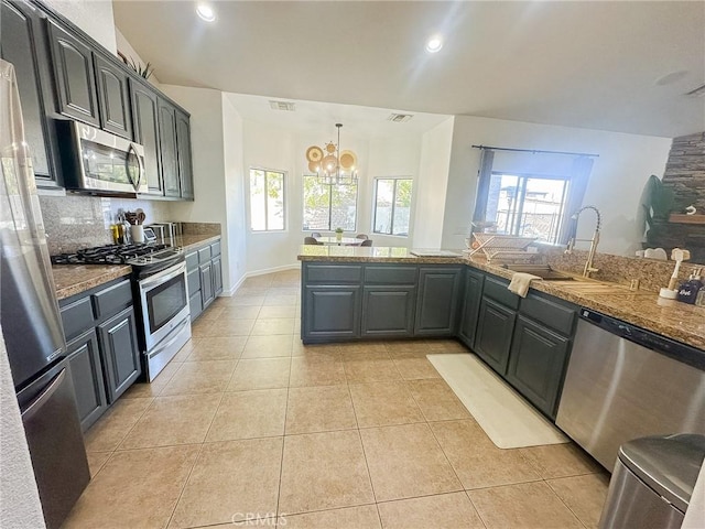 7525 Whitney Ave, Yucca Valley, CA 92284 - kitchen featuring stainless steel appliances, a chandelier, plenty of natural light, light tile patterned floors, and recessed lighting