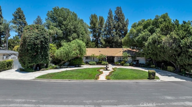 9604 Tunney Ave, Northridge, CA 91324 - single story home featuring a tiled roof, a chimney, a front yard, and stucco siding