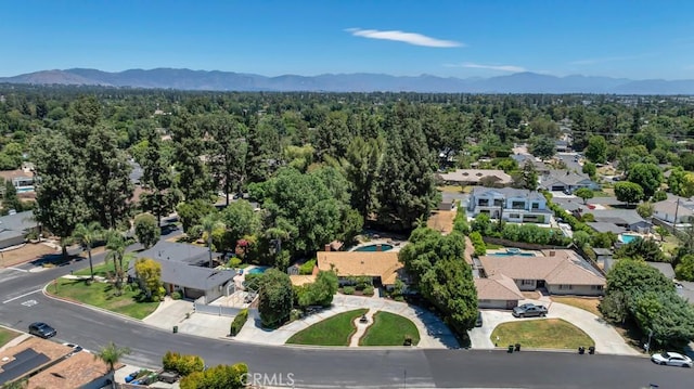 9604 Tunney Ave, Northridge, CA 91324 - aerial view of residential area featuring a mountain backdrop and a heavily wooded area