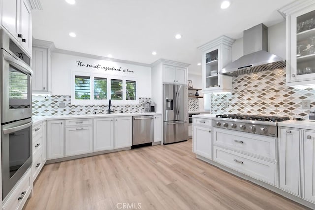 9604 Tunney Ave, Northridge, CA 91324 - kitchen featuring wall chimney range hood, appliances with stainless steel finishes, healthy amount of natural light, decorative backsplash, and recessed lighting