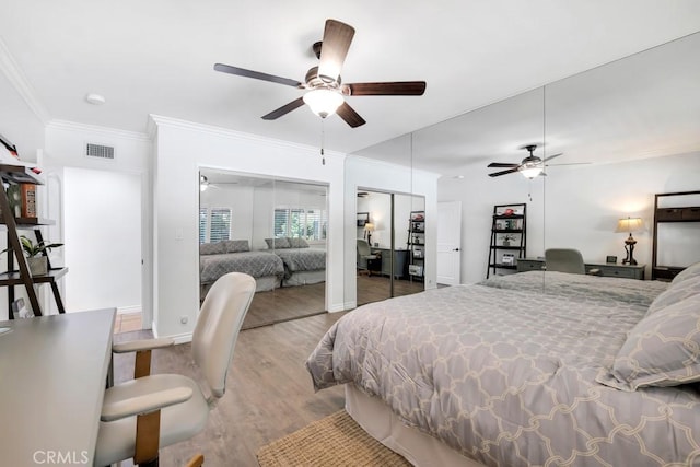 9604 Tunney Ave, Northridge, CA 91324 - bedroom featuring ornamental molding, wood finished floors, a ceiling fan, and multiple closets