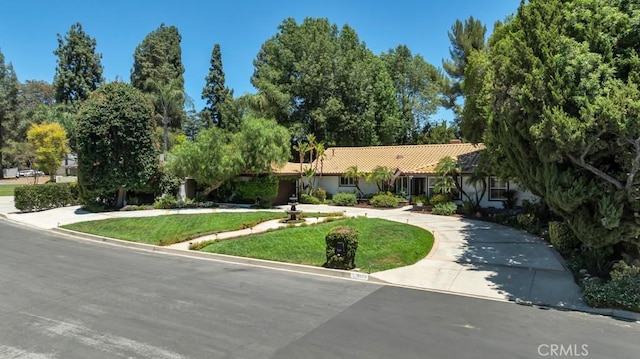 9604 Tunney Ave, Northridge, CA 91324 - view of front facade featuring a tiled roof, curved driveway, a front lawn, and stucco siding