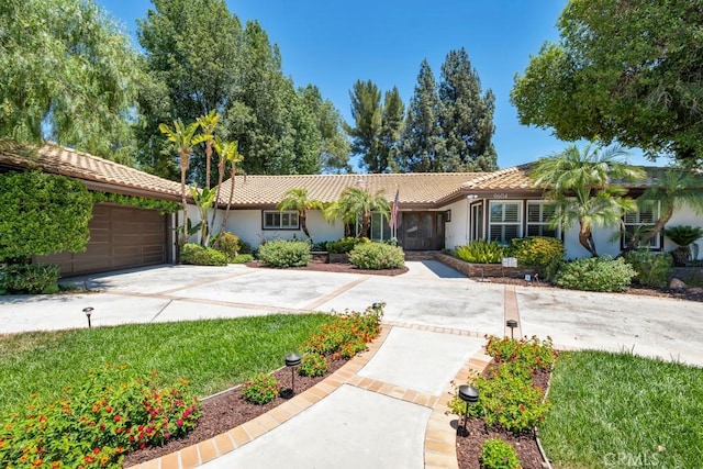 9604 Tunney Ave, Northridge, CA 91324 - ranch-style home with a tiled roof, stucco siding, driveway, and an attached garage