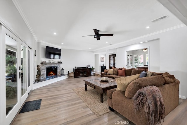 9604 Tunney Ave, Northridge, CA 91324 - living area featuring a ceiling fan, light wood-style flooring, recessed lighting, ornamental molding, and a stone fireplace