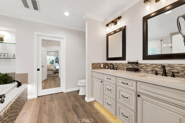 9604 Tunney Ave, Northridge, CA 91324 - ensuite bathroom with double vanity, a bath, wood finished floors, tasteful backsplash, and crown molding