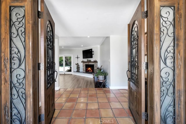 9604 Tunney Ave, Northridge, CA 91324 - tiled entryway featuring a warm lit fireplace, ornamental molding, and recessed lighting