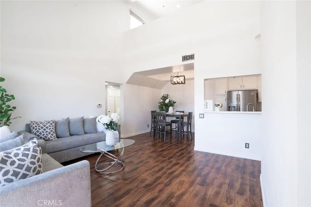 13801 Oxnard St Unit 202, Van Nuys, CA 91401 - living room with a towering ceiling, a chandelier, and wood finished floors