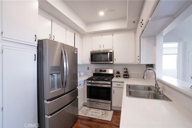 13801 Oxnard St Unit 202, Van Nuys, CA 91401 - kitchen with appliances with stainless steel finishes, light countertops, white cabinetry, and dark wood finished floors