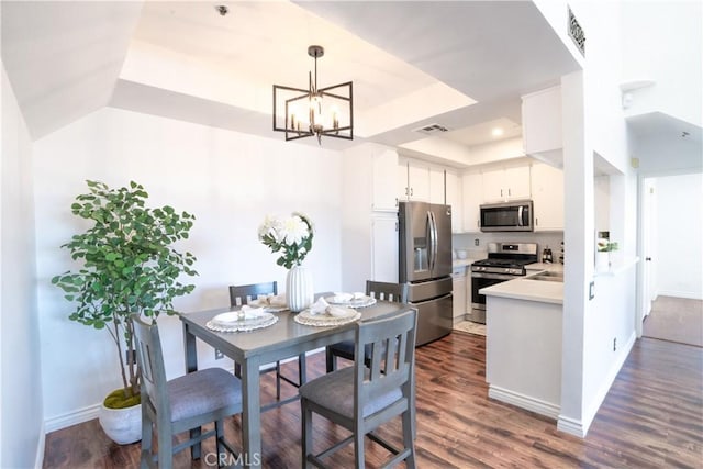 13801 Oxnard St Unit 202, Van Nuys, CA 91401 - kitchen featuring stainless steel appliances, light countertops, a raised ceiling, dark wood-style floors, and a chandelier