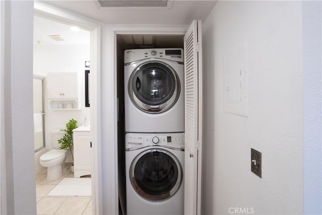 13801 Oxnard St Unit 202, Van Nuys, CA 91401 - washroom featuring stacked washer and clothes dryer and light tile patterned floors