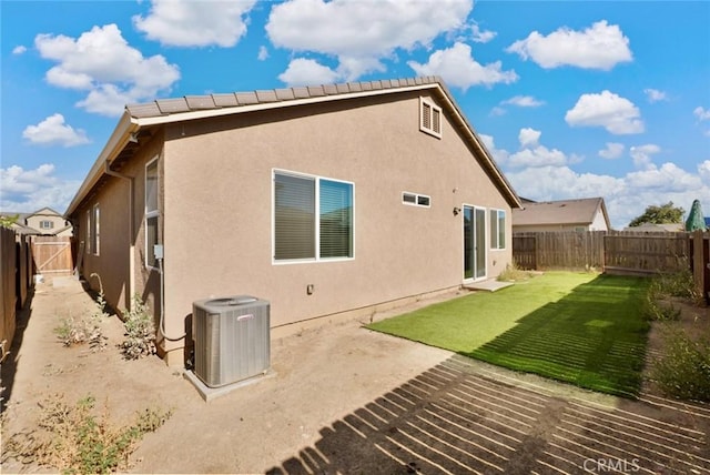 453 Daffodil Dr, Merced, CA 95341 - rear view of property featuring a fenced backyard, stucco siding, and a patio area