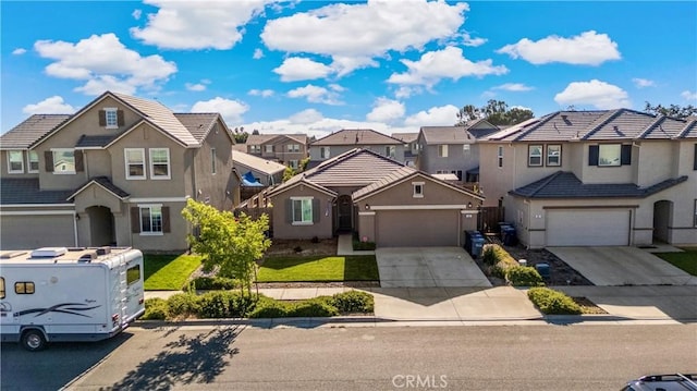 453 Daffodil Dr, Merced, CA 95341 - traditional-style home with a residential view, concrete driveway, a garage, and stucco siding