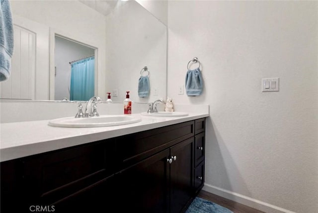 453 Daffodil Dr, Merced, CA 95341 - bathroom with double vanity and wood finished floors