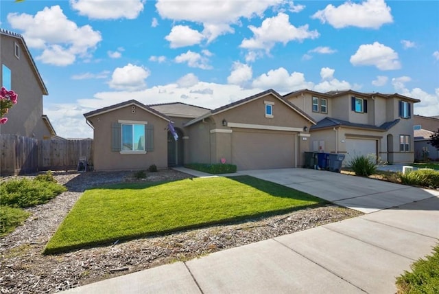 453 Daffodil Dr, Merced, CA 95341 - view of front of house with stucco siding, driveway, and an attached garage