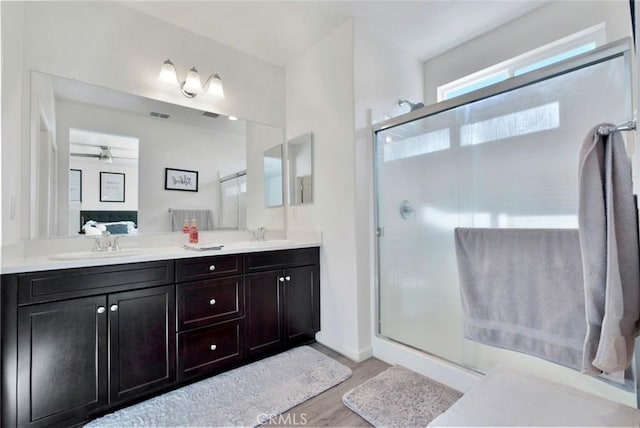 453 Daffodil Dr, Merced, CA 95341 - full bath featuring wood finished floors, a shower stall, double vanity, and ceiling fan