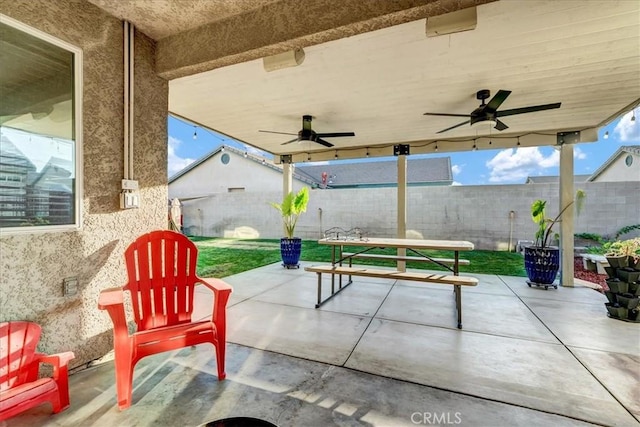 695 Crescent Ln, Lemoore, CA 93245 - fenced backyard with a ceiling fan and a patio area