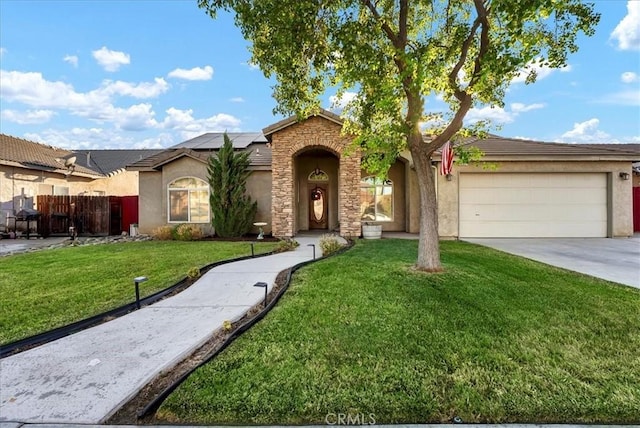 695 Crescent Ln, Lemoore, CA 93245 - ranch-style home with an attached garage, solar panels, stucco siding, driveway, and stone siding