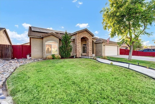 695 Crescent Ln, Lemoore, CA 93245 - view of front of home with solar panels, stucco siding, an attached garage, stone siding, and concrete driveway