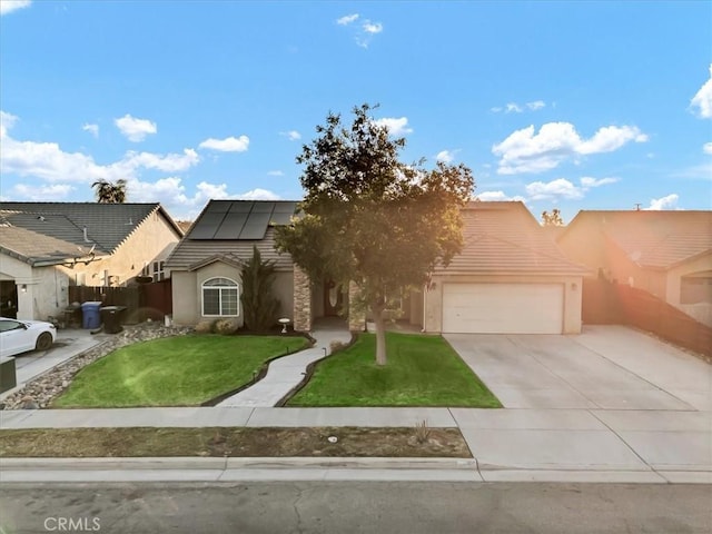 695 Crescent Ln, Lemoore, CA 93245 - view of front of home featuring solar panels, driveway, an attached garage, and stucco siding