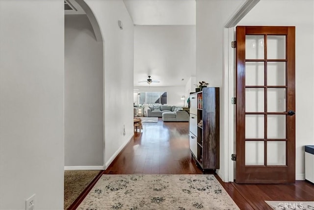 695 Crescent Ln, Lemoore, CA 93245 - hall featuring arched walkways and dark wood-style floors