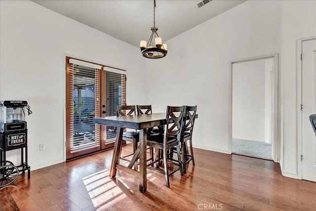 695 Crescent Ln, Lemoore, CA 93245 - dining space featuring a chandelier, wood finished floors, and lofted ceiling