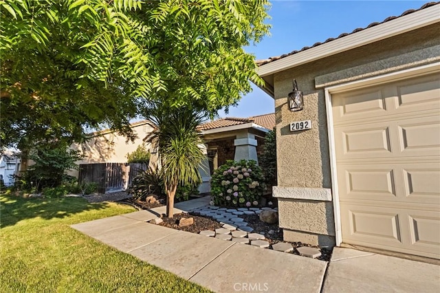 2092 Betsy Ross Ct, Atwater, CA 95301 - property entrance with a tile roof, stucco siding, and a garage