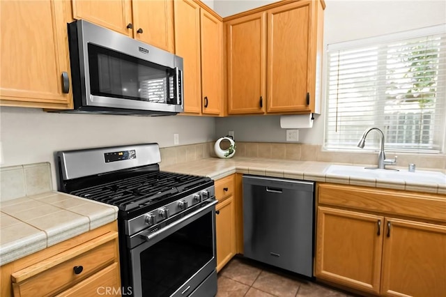 2092 Betsy Ross Ct, Atwater, CA 95301 - kitchen featuring stainless steel appliances, tile countertops, and light tile patterned flooring