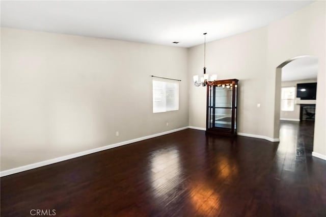 2092 Betsy Ross Ct, Atwater, CA 95301 - empty room featuring a chandelier, wood finished floors, and arched walkways