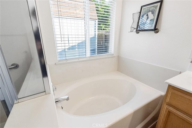 2092 Betsy Ross Ct, Atwater, CA 95301 - bathroom with plenty of natural light, vanity, and a bath