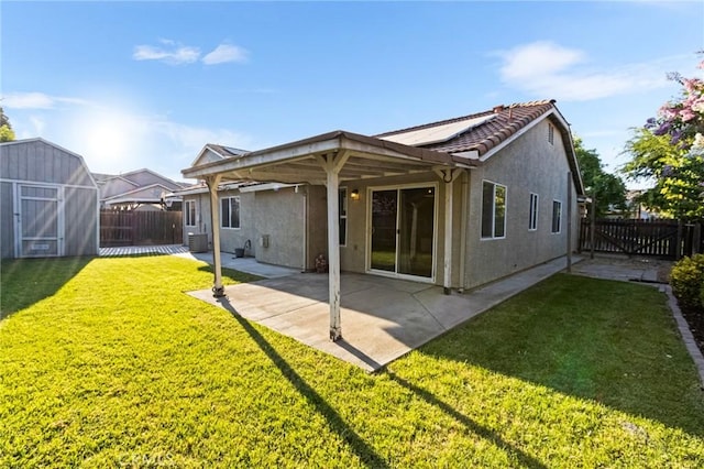 2092 Betsy Ross Ct, Atwater, CA 95301 - rear view of property with a storage shed, stucco siding, a fenced backyard, a patio, and solar panels