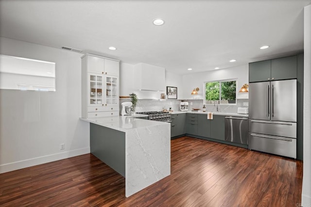 9312 Daisy Ave, Fountain Valley, CA 92708 - kitchen featuring stainless steel appliances, dark wood finished floors, a peninsula, recessed lighting, and tasteful backsplash