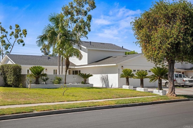 9312 Daisy Ave, Fountain Valley, CA 92708 - view of front facade with a front yard, an attached garage, driveway, and stucco siding