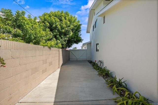 9312 Daisy Ave, Fountain Valley, CA 92708 - view of side of home featuring stucco siding and a gate