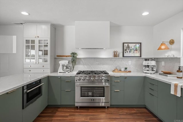 9312 Daisy Ave, Fountain Valley, CA 92708 - kitchen featuring high end stainless steel range oven, green cabinetry, light stone countertops, decorative backsplash, and recessed lighting