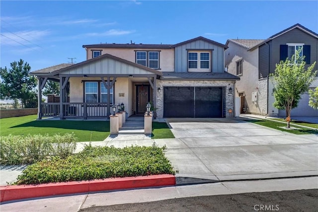 16614 Trailblazer Ave, Chino, CA 91708 - view of front facade with covered porch, concrete driveway, a garage, stucco siding, and board and batten siding