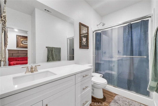 16614 Trailblazer Ave, Chino, CA 91708 - bathroom featuring a stall shower, vanity, and wood finished floors