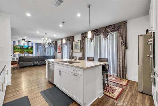 16614 Trailblazer Ave, Chino, CA 91708 - kitchen featuring light countertops, wood finished floors, a chandelier, stainless steel dishwasher, and an island with sink