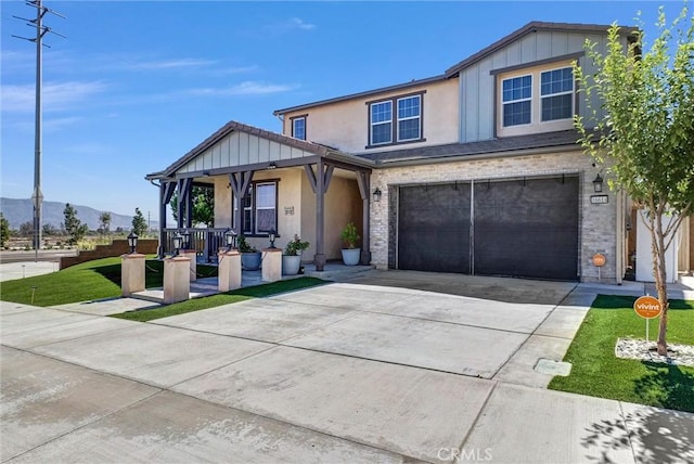 16614 Trailblazer Ave, Chino, CA 91708 - view of front facade featuring a porch, stucco siding, concrete driveway, a garage, and a mountain view