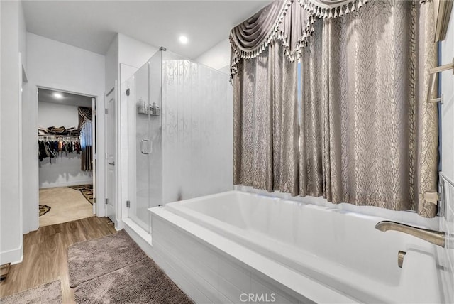 16614 Trailblazer Ave, Chino, CA 91708 - full bath featuring a stall shower, a garden tub, a spacious closet, and wood finished floors