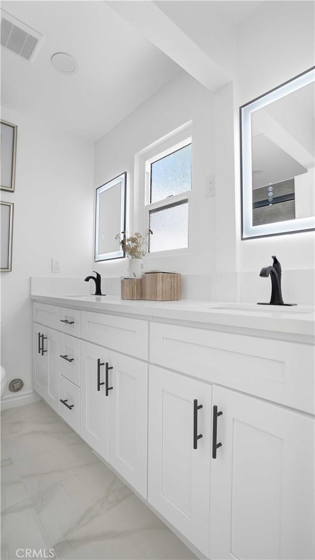 23231 Cheswald Dr, Laguna Niguel, CA 92677 - bathroom featuring double vanity and marble look tile flooring