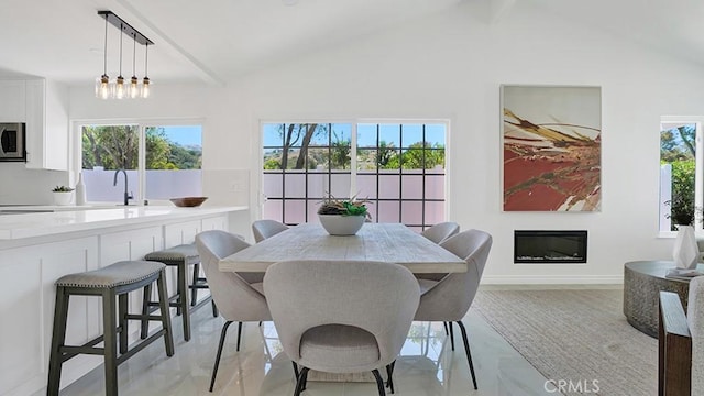 23231 Cheswald Dr, Laguna Niguel, CA 92677 - dining space with a glass covered fireplace and baseboards