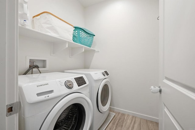 4192 Camino Campana, Oceanside, CA 92057 - laundry room with light wood-type flooring and washing machine and dryer