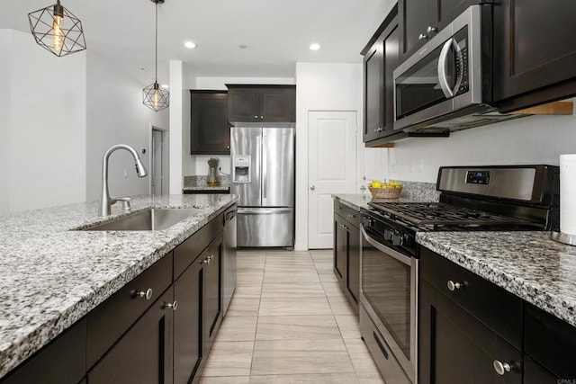 4192 Camino Campana, Oceanside, CA 92057 - kitchen with appliances with stainless steel finishes, light stone counters, decorative light fixtures, light tile patterned floors, and recessed lighting