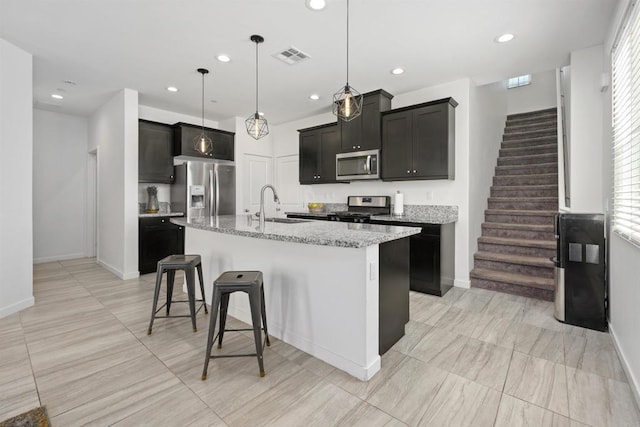 4192 Camino Campana, Oceanside, CA 92057 - kitchen featuring stainless steel appliances, a kitchen island with sink, light stone countertops, recessed lighting, and healthy amount of natural light